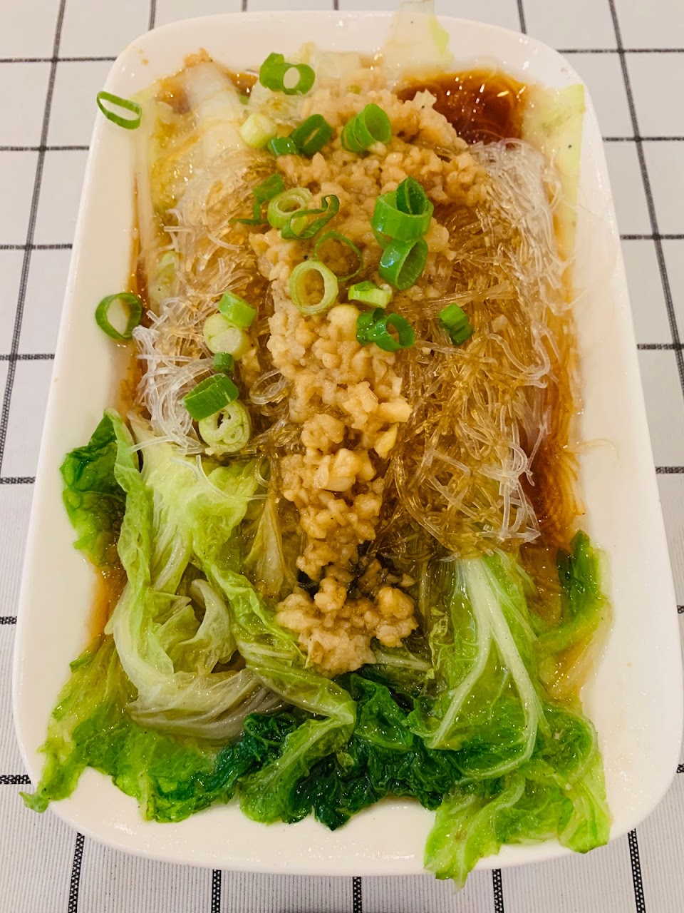 Noodle and greens dish plated at Spice Paradise